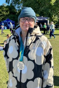 Jane wearing a medal and smiling.