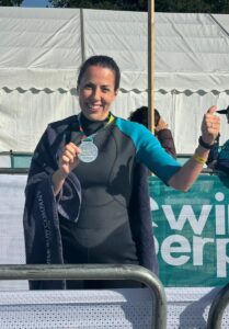 Nefer wearing a medal and smiling.